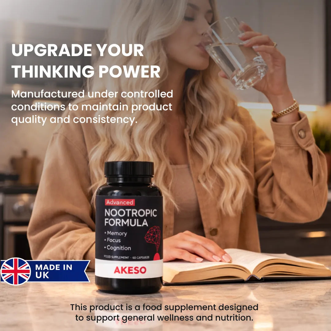 Woman drinking water while reading, with a bottle of Akeso Advanced Nootropic Formula on the table